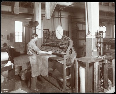 Vista interior de un hombre trabajando con cuero en la New York Leather Belting Co., Nueva York, 1906 de Byron Company